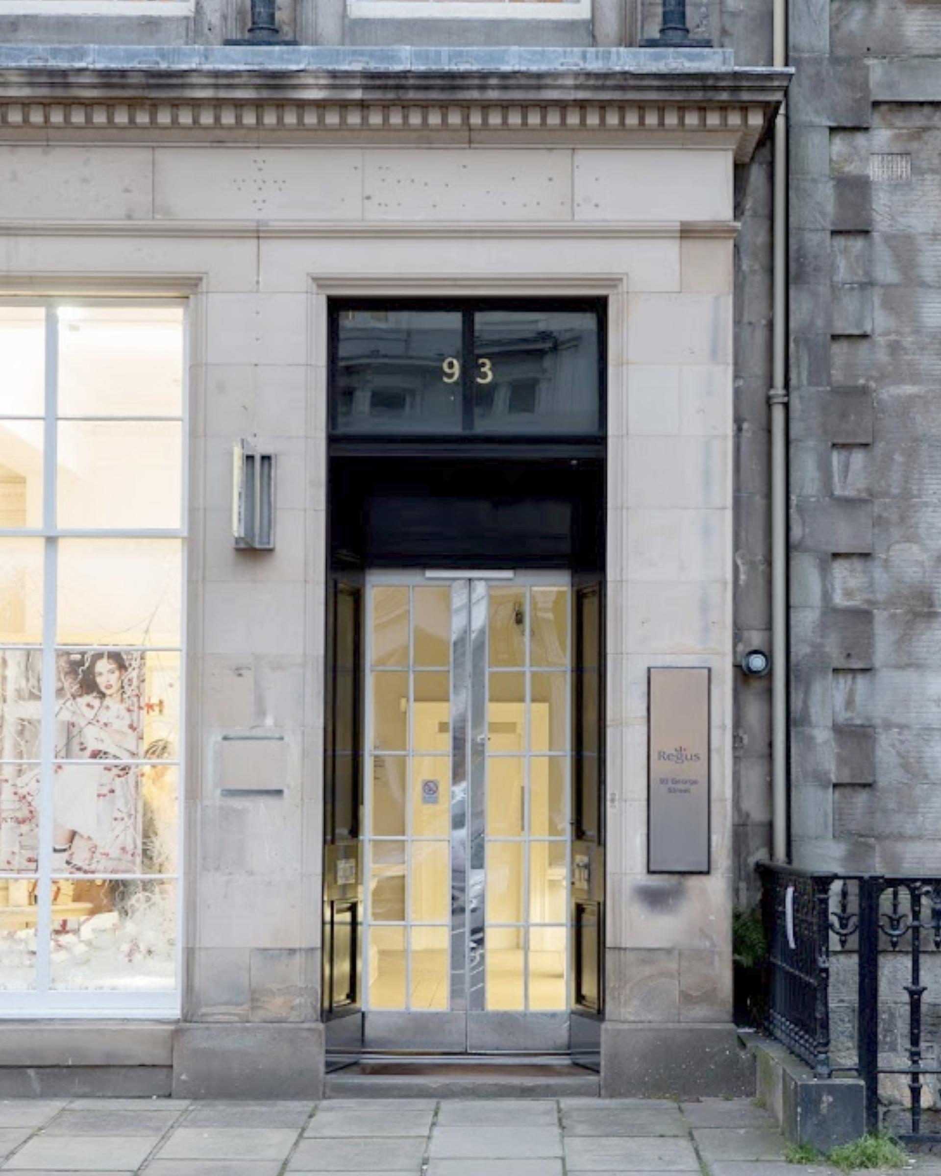 Historic building in Edinburgh with columns, large windows, and pedestrians