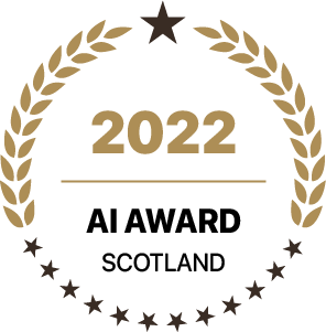 Gold laurel wreath circle badge indicating 2022 AI Award Scotland